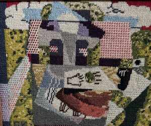 Needlepoint by Dina Paul's grandmother: a village scene with a set table in a garden